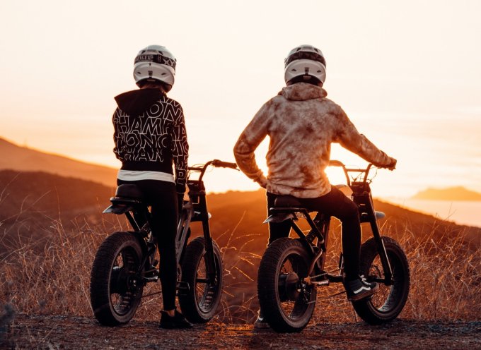 Dwaj chłopcy cieszą się swoimi prezentami komunijnymi rowerami elektrycznymi